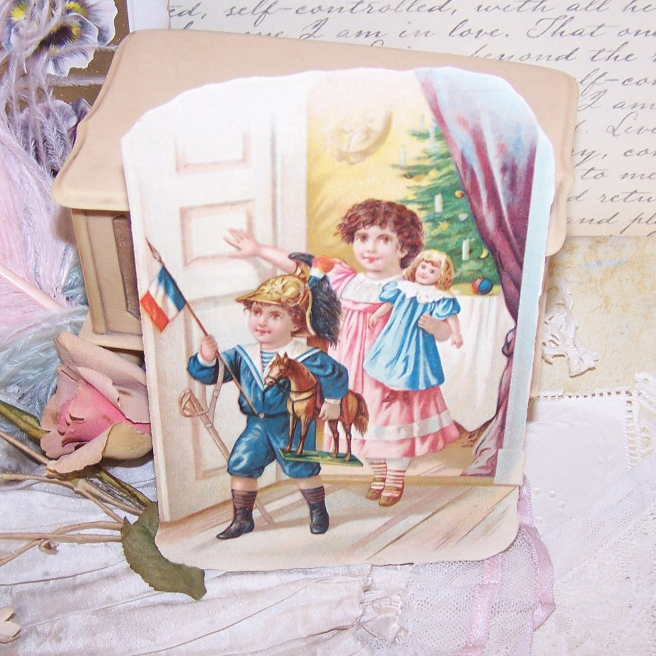 A holiday Victorian die cut that depicts children exiting a room with their new toys that were placed under the Christmas Tree.  5-1/2" x 3-3/4" approx. 