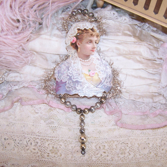 Handcrafted OOAK tinsel and mercury glass Christmas ornament with an Antique Victorian die cut of a lady wearing a shawl. Light but lengthy. One of a Kind.