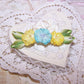 Art Deco French ombre ribbonwork floral spray in colors of yellow / turquoise blue; the centers hold glass beads. End leaves are lime green. 2-1/4" x 5/8". 