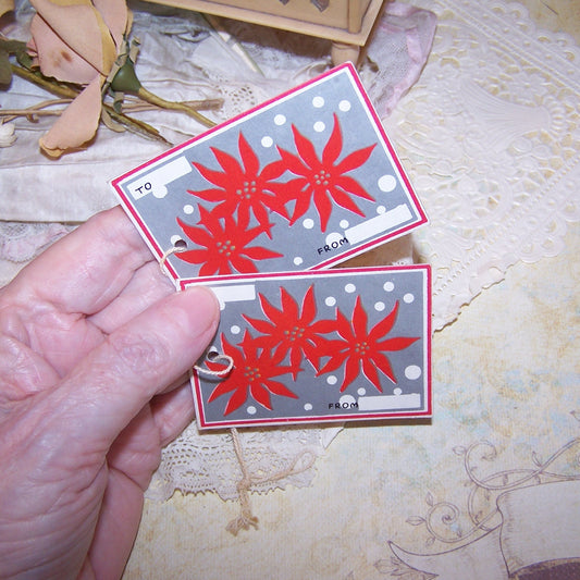 2 Art Deco unused Christmas Gift package tie ons - To and From tags.  Image of a Red Poinsettia. Unused condition - vintage patina to the paper. Unknown maker. 