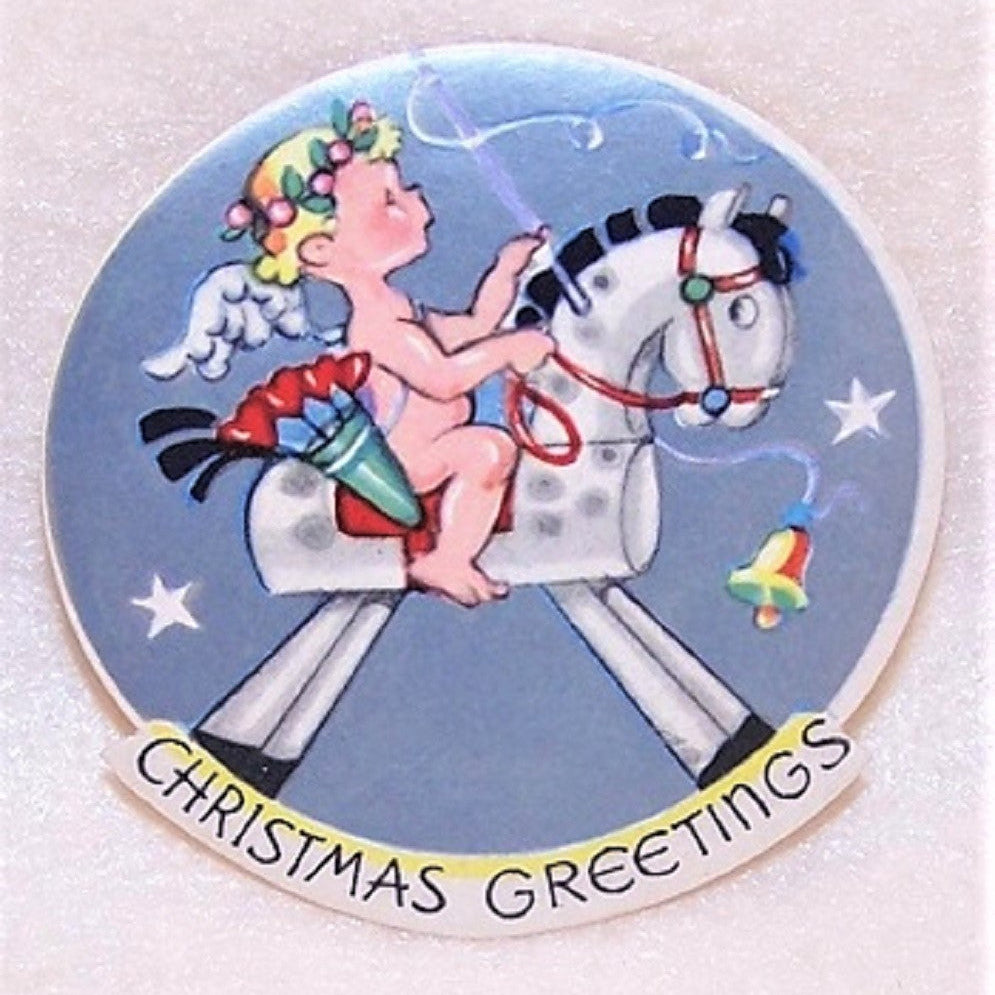 3 Art Deco gummed round Christmas Stickers with the image of an angel riding a rocking horse. Unused condition - vintage patina to the paper. Unknown maker. 