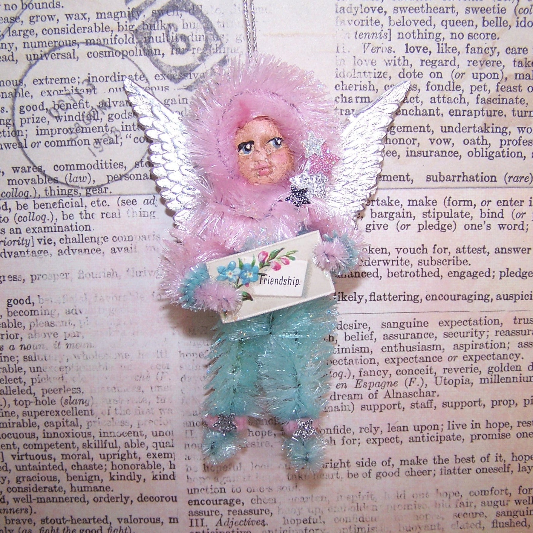 OOAK Chenille Angel carrying an Antique Victorian FRIENDSHIP placard.  For Christmas or any day, the little girl has a face of handpainted clay.  3.5" x 2.5"