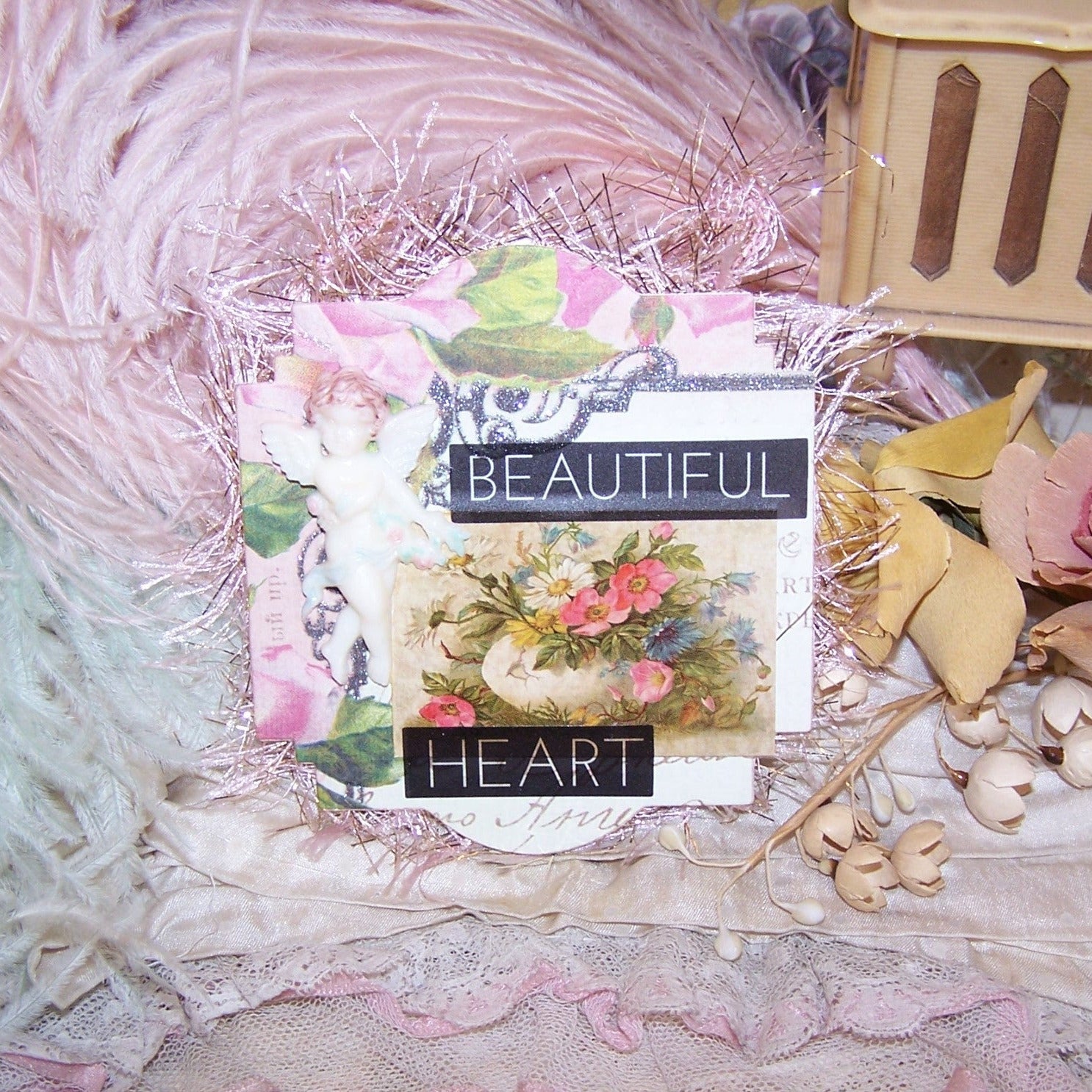 BEAUTIFUL HEART - a light cardstock ornament featuring a hand tinted plastic cupid - cherub - putti - angel decoration.  Floral graphics complete the design.