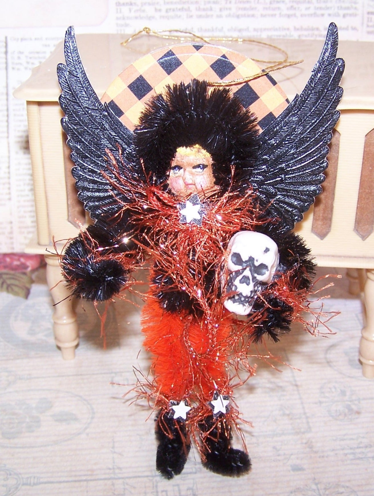 A mixed media OOAK "Dark Angel" Halloween ornament. My Black/Orange little girl stands guard with skull in hand.  A cute holiday accent for any area.  