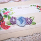 French Revival ribbonwork spray of 3 florals - a blue silk cabbage rose shouldered by a pair of mauve silk florettes, the centers set with freshwater pearls. 