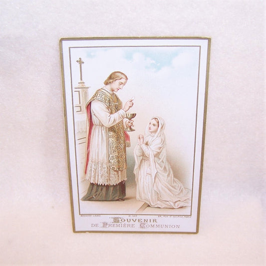 Souvenir de Premiere Communion printed by the French firm of Bouasse-Lebel. The card  features a color image of a young girl taking communion. 2-3/4" x 4-3/8".