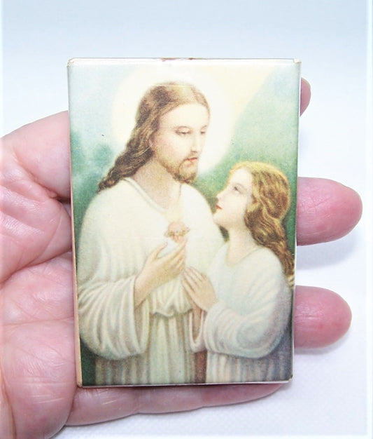 Made in USA celluloid religious easel image depicting Jesus Christ and a young child. The image is done in hushed pastel tones. 3-1/8" x 2-1/8".