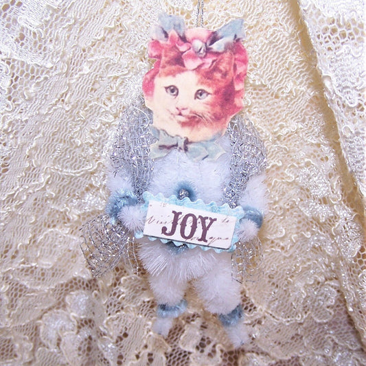 Handmade chenille ornament designed in a Victorian Revival manner.  A tabby cat carries a sign reading JOY.  One of a Kind decoration for Spring. 