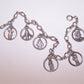 Sterling Silver 7" charm bracelet by Creed holding 6 religious charms - Jesus Christ, Virgin Mary, Infant of Prague, Saint Joseph, St Anthony and St Christopher.