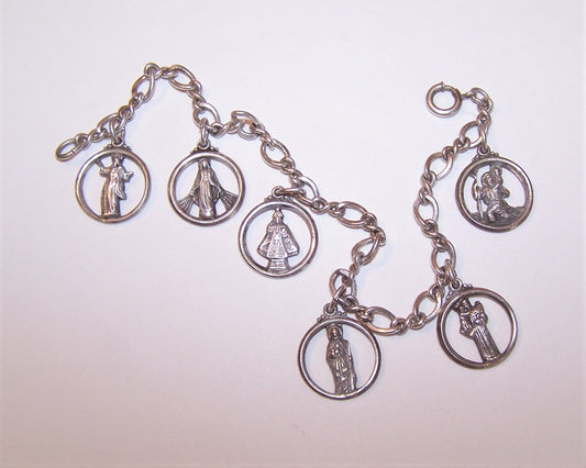 Sterling Silver 7" charm bracelet by Creed holding 6 religious charms - Jesus Christ, Virgin Mary, Infant of Prague, Saint Joseph, St Anthony and St Christopher.