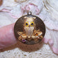 For Halloween from DANKNER, here's a 14K Yellow Gold disc charm depicting an Owl sitting on a branch.  Width/height is 1-1/8". Weight is 8.3 grams. 