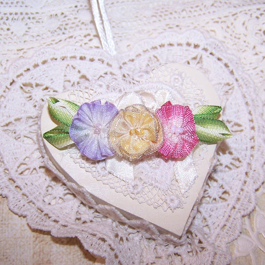 Art Deco French ombre ribbonwork floral spray in colors of yellow, pink and lavender; the centers hold glass beads. End leaves are lime green. 2-1/4" x 5/8". 