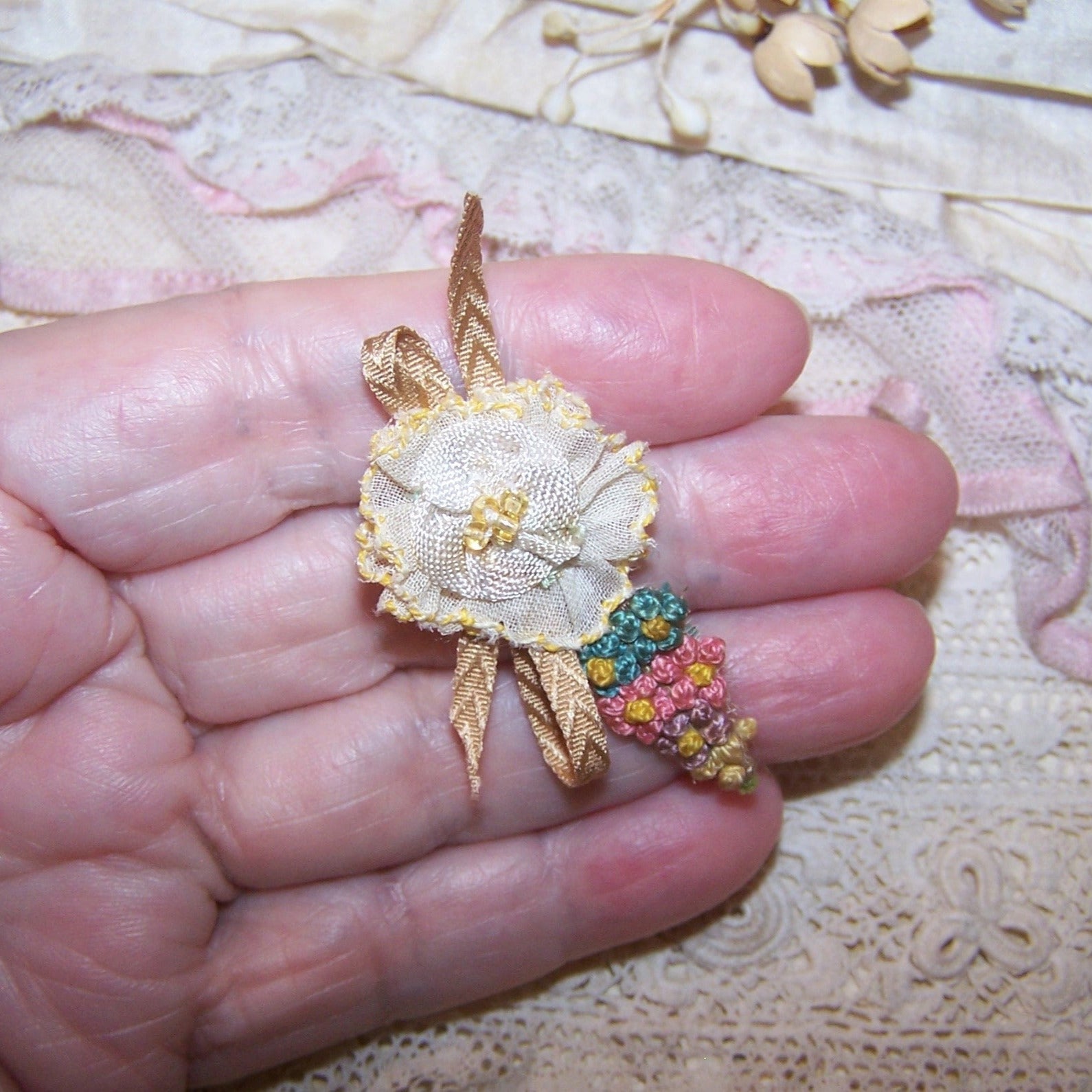 Antique French ribbonwork - a yellow organza flower, seed beads at the center; floss embroidery end with Beige flourish.  1-7/8" x 1" approx. Handsewn.