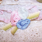 A trio of pink, ice blue and French blue silk florals rest on a background of lime green ombre cotton ribbon.  Size is 2-3/8" x 1-1/8". Entirely handsewn.