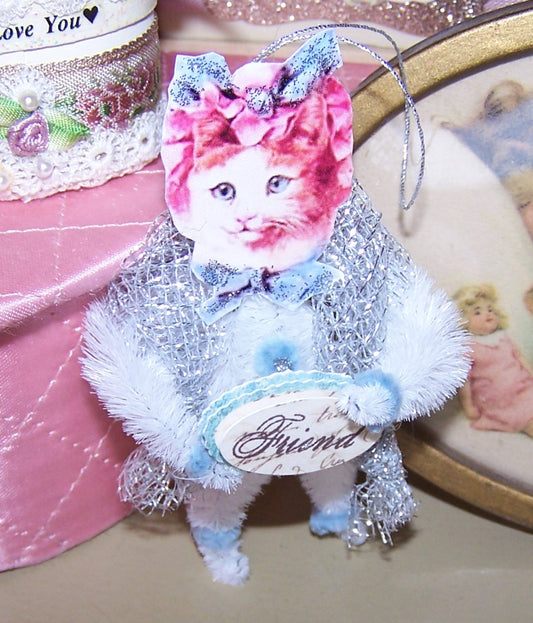 Handmade chenille ornament designed in a Victorian Revival manner.  A tabby cat carries a sign reading FRIEND.  One of a Kind decoration for Spring. 
