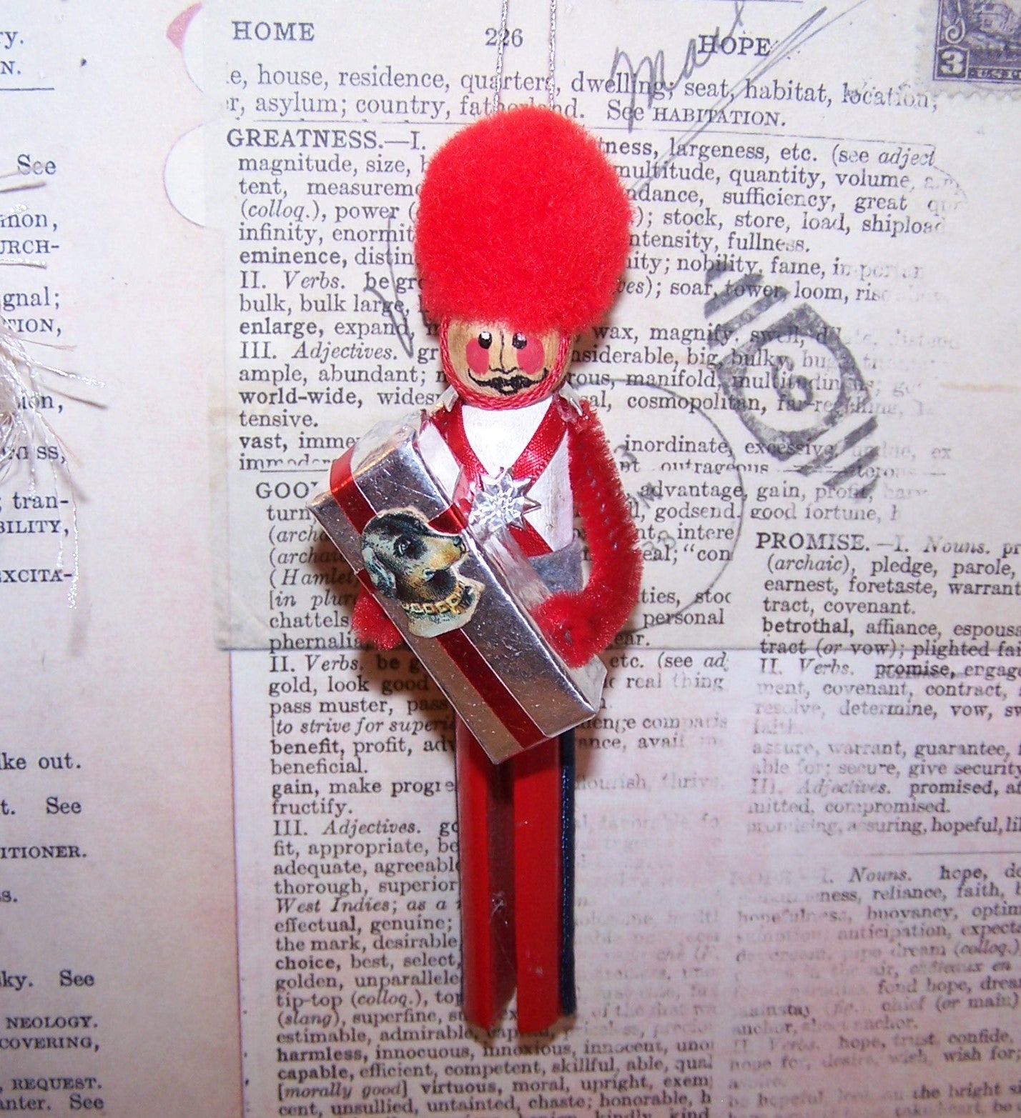 Vintage hand painted wooden ornament - red, white and blue soldier carrying a gift package adorned with an Antique Victorian die cut of a dog's head.  