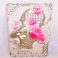 Gorgeous Antique Greeting Card! Heavily embossed with pink roses sitting in a bridal basket, the sentiment is HEARTY GREETINGS.   Size is 6" x 4-1/2" closed.