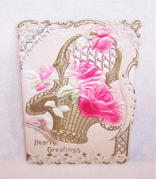 Gorgeous Antique Greeting Card! Heavily embossed with pink roses sitting in a bridal basket, the sentiment is HEARTY GREETINGS.   Size is 6" x 4-1/2" closed.