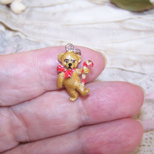 Jezlaine sterling silver and enamel Christmas charm.  Teddy Bear holding a candy cane.  3/4" high (without bale and ring) x 9/16". 3.5 grams. Adorable!