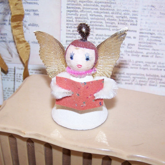 Vintage Made in Japan Christmas angel ornament. Made of mixed materials, she stands 2-1/4" high x 1-7/16".  Very nice condition.  Hang or stand on a mantel.