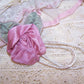 Handsewn Revival French Ribbonwork mauve satin rose / ribbon leaf / cream cord applique or dress embellishment.  Size is 1-3/4" wide/high.  