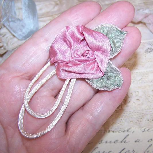 Handsewn Revival French Ribbonwork mauve satin rose / ribbon leaf / cream cord applique or dress embellishment.  Size is 1-3/4" wide/high.  