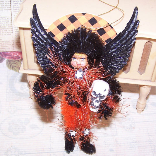 A mixed media OOAK "Dark Angel" Halloween ornament. My Black/Orange little girl stands guard with skull in hand. A cute holiday accent for any area. 