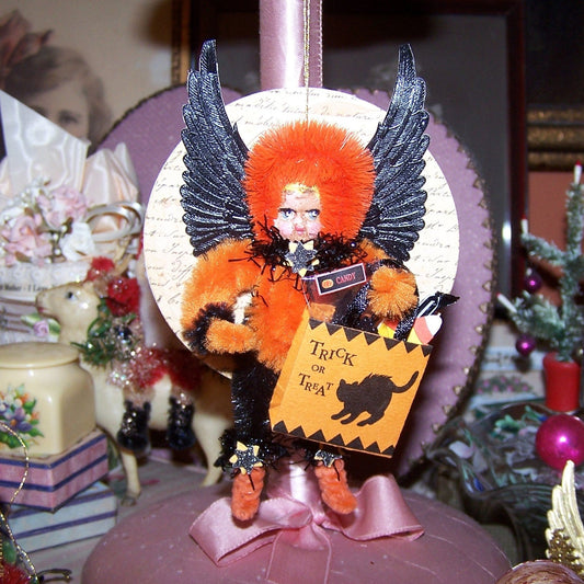 Mixed media OOAK "Dark Angel" Halloween ornament. A little girl in Black/Orange holds a Trick or Treat bag filled with candy.  A holiday accent for any area.  