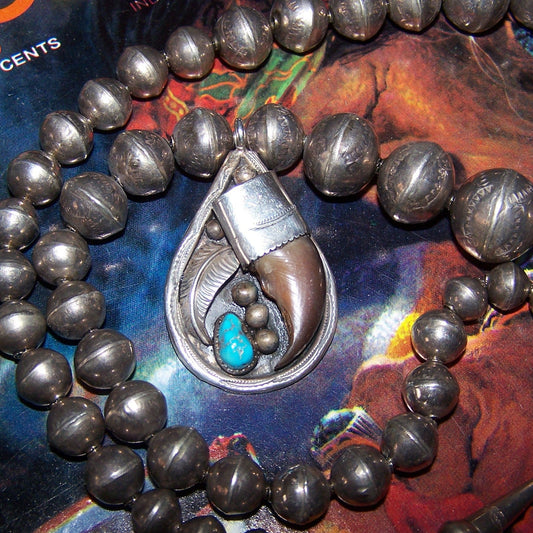 Vintage Native American Navajo Sterling Silver Turquoise and Claw pendant.  Teardrop shaped with no makers mark.  1-3/4" x 1-1/4". 15 grams. 