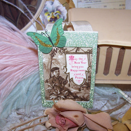 OOAK handcrafted ornament for the New Year.  Japanaise-style, the glitter rectangle is an Antique Victorian trade card.  Repro photographer's label on back. 