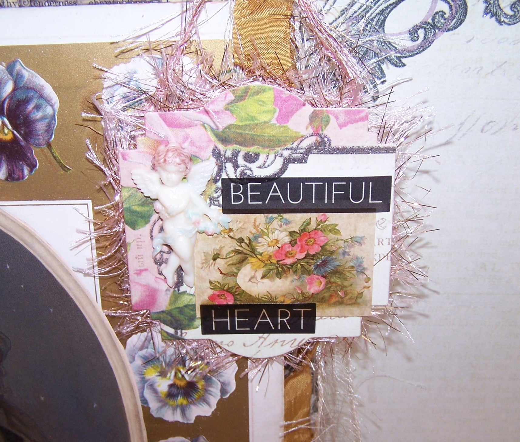 BEAUTIFUL HEART - a light cardstock ornament featuring a hand tinted plastic cupid - cherub - putti - angel decoration.  Floral graphics complete the design.