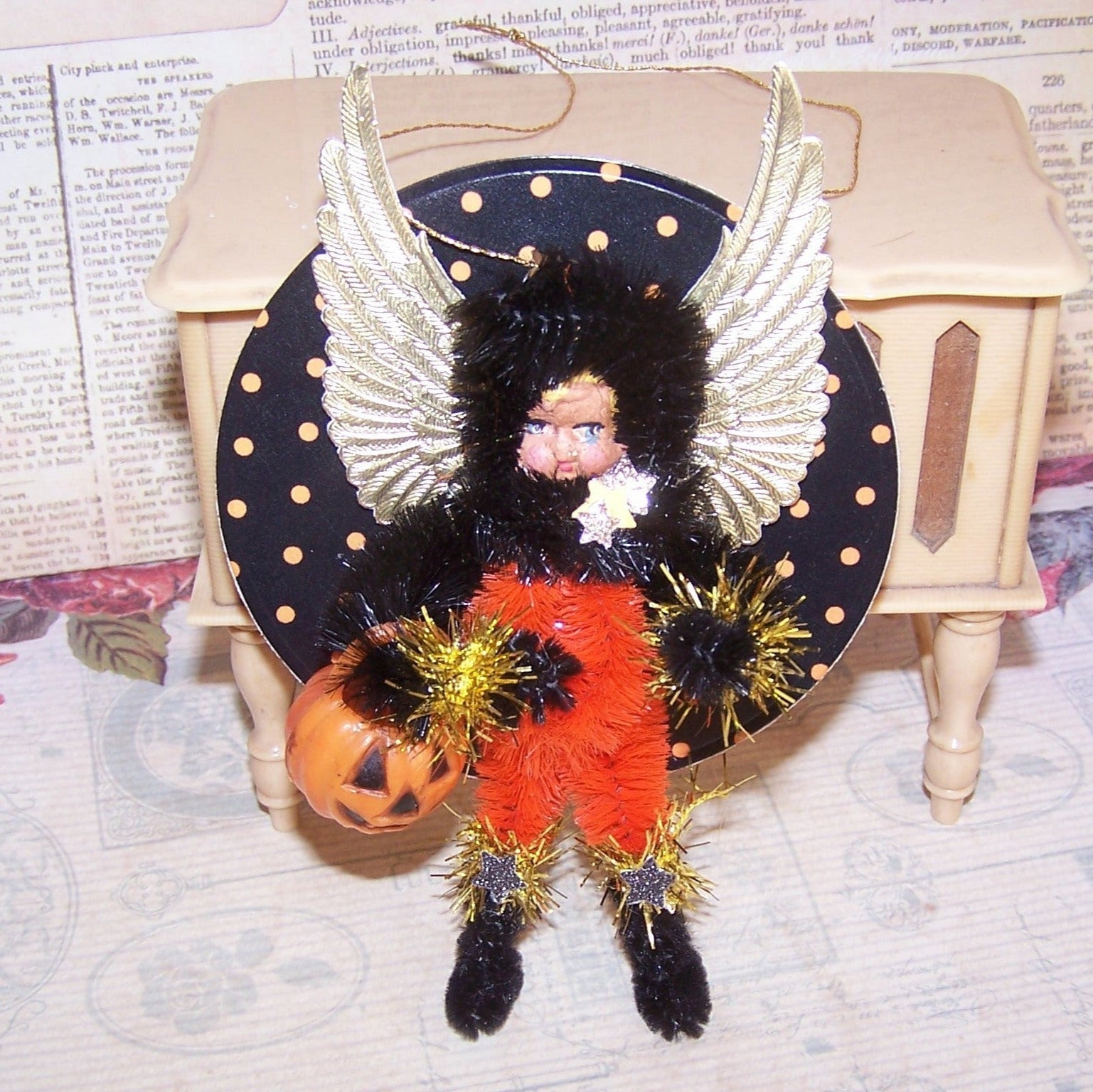 A mixed media ONE OF A KIND "Dark Angel" Halloween ornament . My little girl "trick or treater" carries a Jack O Lantern bucket and is a perfect holiday accent.