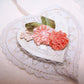 Handsewn ribbon applique of peach / orange silk flowers.  Olive green leaves and sugar pips add to the look of the embellishment.  Size is 1-7/8" x 1-1/8". 