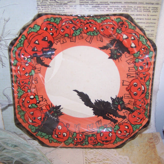 In an unopened state, but the cellophane covering has punctured and split. Set of 8 Art Deco era Halloween 8" paper plates by Perkins.  Black cats & Pumpkins.