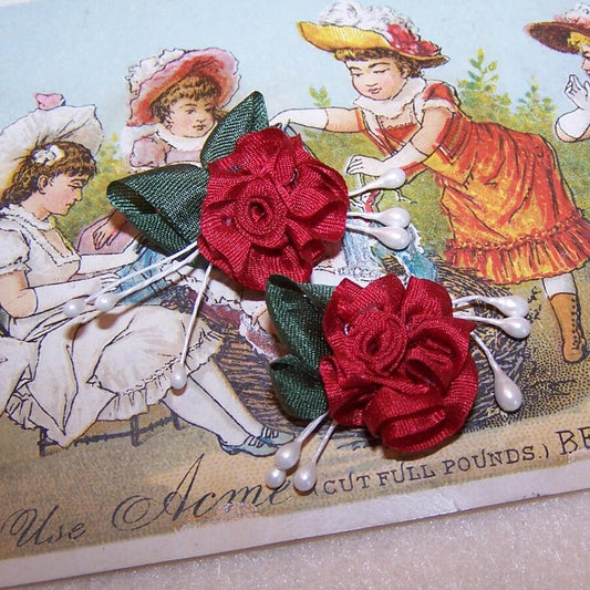 Set/2 hand sewn red silk / hunter green ribbon flowers. With white sugar pips acting as background, the roses can be applied to any number of projects