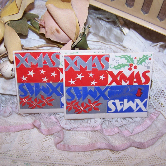 7 Christmas Stickers / Seals in a red, white & blue patriotic coloring. Rectangular in shape, graphics include holly, poinsettias and stars. Unknown maker.