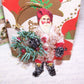 Retro Look glittered chenille Santa Claus Christmas ornament.  Repro Victorian die cut face, Dresden paper accents & a bottlebrush wreath complete the design.  