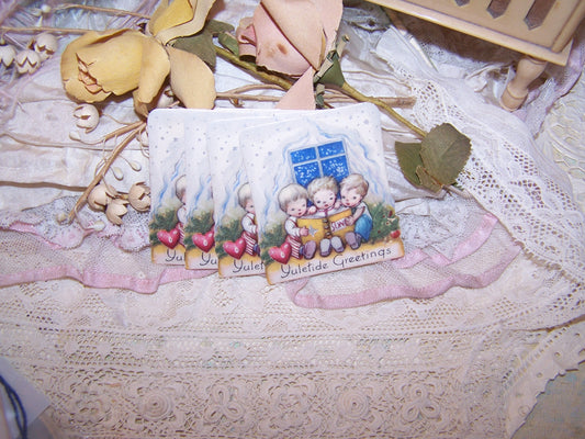 4 vintage Christmas Stickers - Seals of children reading a book.  Sentiment is Yuletide Greetings.  Mint, unused condition.  Rectangle shape.  Unknown maker.