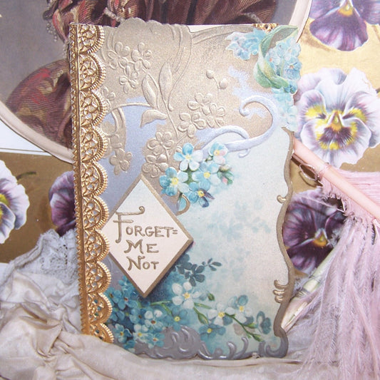 Upcycled greeting card.  Forget Me Not cover with Christmas wishes on the inside.  Can be presented once more.  Comes with envelope. Size is 4-1/2" x 3".