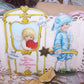 An upcycled Valentines Day card depicting a Georgian era scene of a young boy holding the handles of a Georgian sedan chair; Cupid sits on the inside.