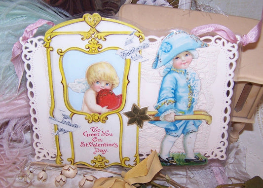 An upcycled Valentines Day card depicting a Georgian era scene of a young boy holding the handles of a Georgian sedan chair; Cupid sits on the inside.
