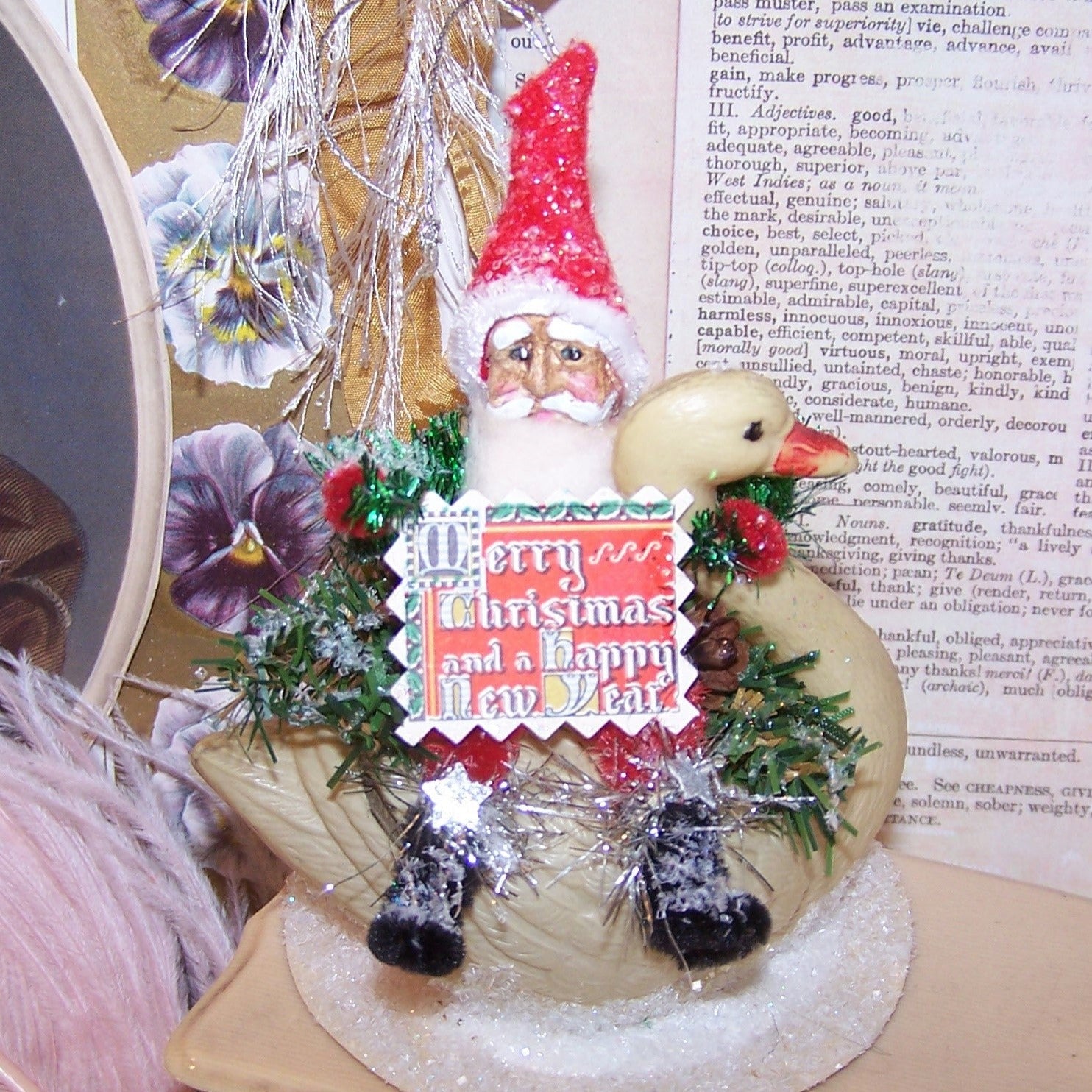 OOAK Chenille Santa Claus riding an upcycled Art Deco era celluloid swan.  Sentiment is "Merry Christmas and a Happy New Year." 4-3/4" x 3-1/2". Lightweight.