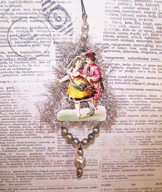 Victorian Revival handcrafted silver tinsel and mercury glass Christmas ornament.  Antique die cut of a dancing couple. Light but lengthy. One of a Kind