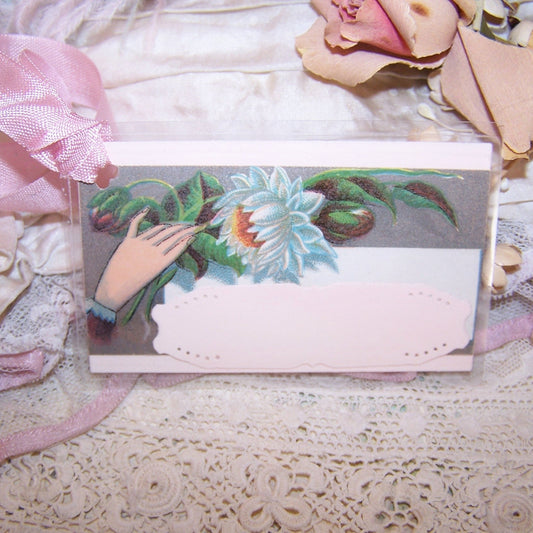Antique Victorian Revival mixed media re-useable gift tag - package tie. Cardstock is overlaid with a calling card displaying a hand holding a chrysanthemum. 
