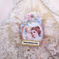 Victorian Revival Mother's Day ornament or decoration.  A puffy fabric oval holds the image of a Mother and Child as well as cream fabric with gold highlights.