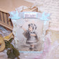 Made of paper & ribbon, here's an everyday ornament or gift tag. Front graphic is an Antique Victorian image of a little girl with a bird.  Sentiment is DELIGHT. 