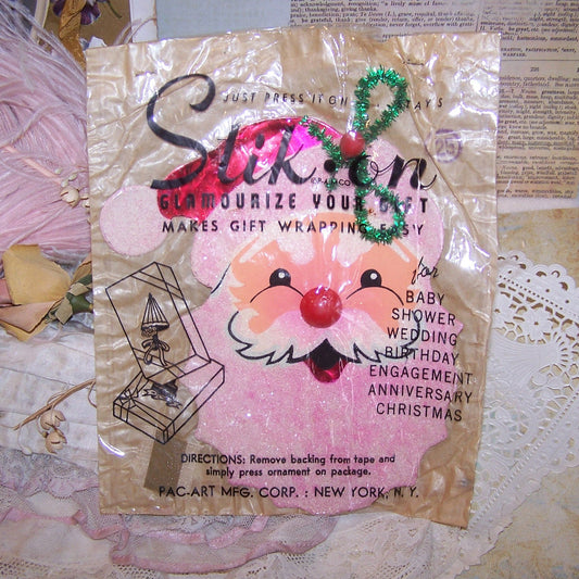 1950s package holding a Stik-On by Pac-Art Mfg Corp, N.Y. - a foiled, mica'ed Santa Claus that would have been stuck to a Christmas present.  6-1/2" x 4-1/2"