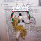 Vintage spun cotton, chenille and gold tinsel holiday ornament.  Frosty the Snowman carries a Merry Christmas banner.  Cord at back for hanging on a tree.