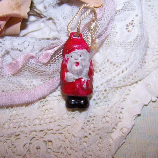 Art Deco Japan celluloid Cracker Jack/gumball charm/ornament of Santa Claus. Size is 1-3/16" high x 1/2" wide. Perfect feather tree ornament. 