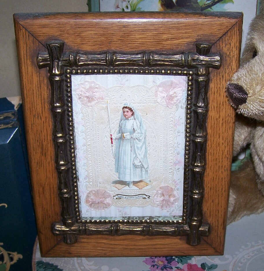 From France, C.1890 or so, here's a framed Souvenir of a First Communion for a girl. Set inside an Antique Victorian wooden frame with a decorative brass bamboo inner section, the image size is 3-3/4" x 5-1/2". The frame measures 7-1/8" wide x 9-1/8" high.  Original glass. 